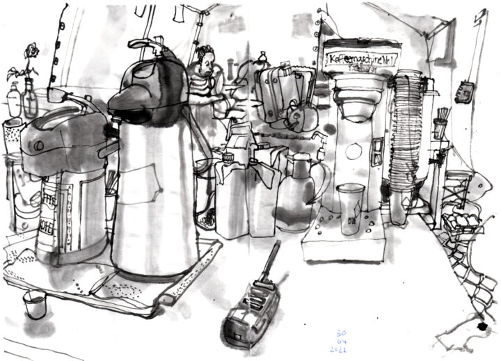 Ink drawing of a coffee machine, two large thermos coffee suppliers, milk crates, paper cups and other stuff on a table, that serves as counter in a tent. In the background is a man at a table, a suitcase and other luggage.
